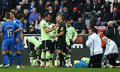 Massadio Haidara reels in pain following a challenge from Wigan's Callum McManaman