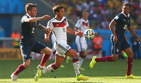 Mathieu Debuchy battles for possession with Germany's Mario Gotze